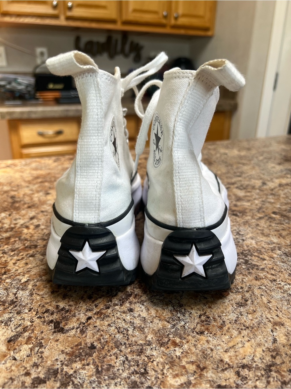 Women’s Converse White High-Top Canvas Sneakers.